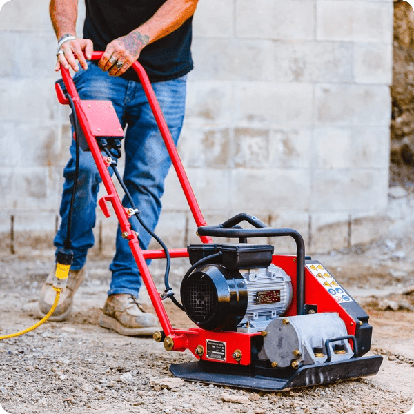 Plate compactor in use on small residential job
