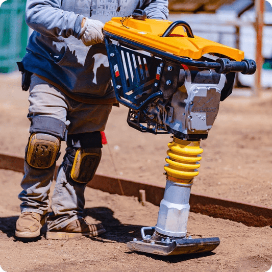 Side view of jumping jack tamper in use