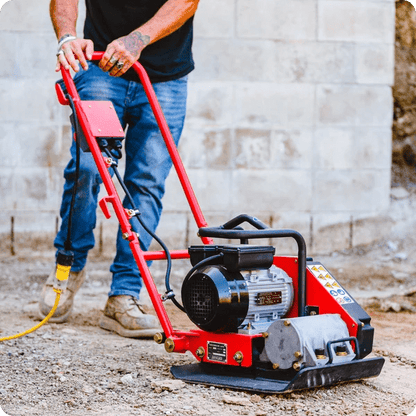 Plate compactor in use on small residential job