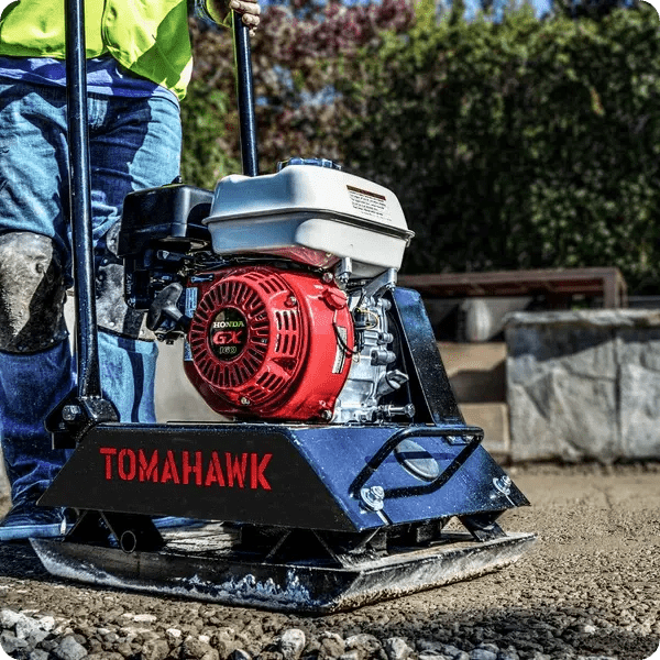 Side view of a vibratory plate compactor ready for use