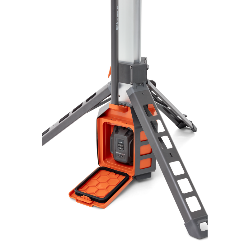Studio image showing a Husqvarna construction light with a battery compartment.
