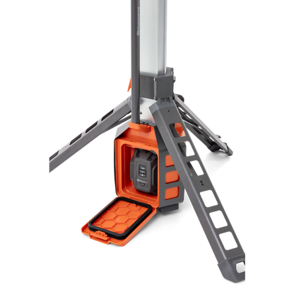 Studio image showing a Husqvarna construction light with a battery compartment.
