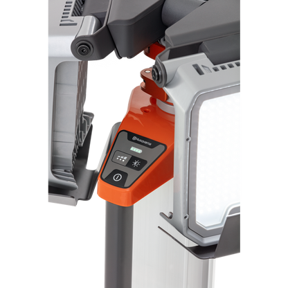 Close-up of a Husqvarna construction light with control panel and adjustable stand.