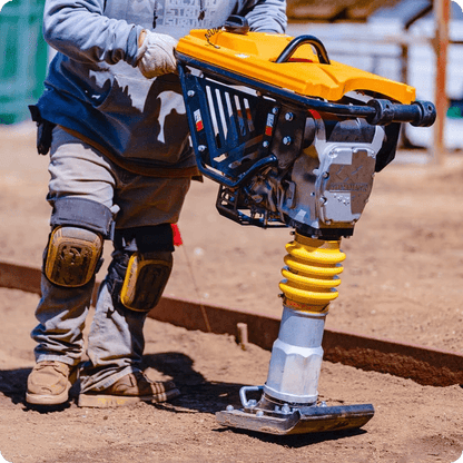 Side view of jumping jack tamper in use