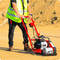 Side view of compact vibratory tamper on gravel