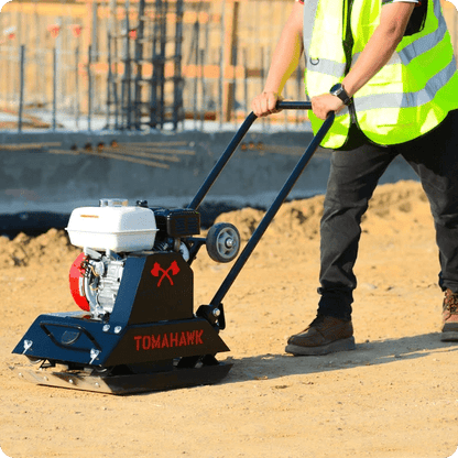 Side view of plate compactor on gravel